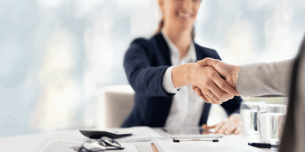 Two individuals settling a business dispute via negotiation, an alternative to court