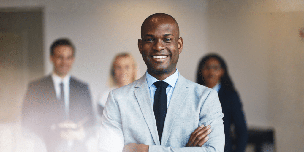North Carolina small business owner standing with his team after choosing a business structure