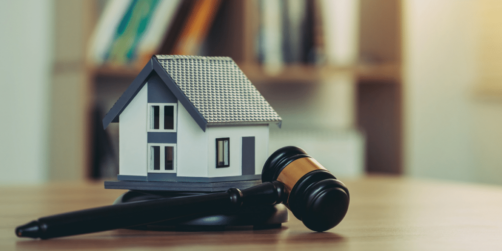 Model house and judge's gavel representing a real estate partnership dispute